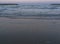 A nice sunset scene of a the sea beach and Groynes with a sea water splashing against them as they down the pebble beach