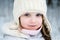 Nice toddler girl in white winter hat