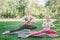 Nice view of adult and kid spending time together. They are stretching right hand and keeping balance with the other