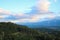 Nice view from a height to the green dense forest and mountains in the evening