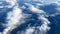 Nice view from the window of the plane to the blue sky, white clouds and the earth. Flying over the clouds.