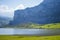 Nice views of Ercina Lake in Covadonga, Asturias, Spain. Green grassland with a glaciar lake and mountains at the background