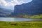 Nice views of Ercina Lake in Covadonga, Asturias, Spain. Green grassland with a glaciar lake and mountains at the background