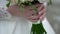 Nice wedding bouquet in bride`s hand. Clip. Fiancee in a beautiful white dress holding a beautiful bouquet of wedding