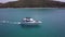 Nice white motorboat takes boat coming out of bay to open ocean, tropical island
