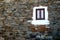 Nice window with curtains of a typical stone facade of Portugal