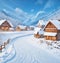 Nice winter landscape. Lovely houses in the snowy valley. Winter walk.