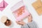 Nice young woman holding a box with macaroons