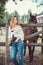 Nice young woman with a horse on rancho, outdoor portrait