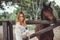 Nice young woman with a horse on rancho, outdoor portrait