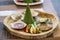 Nicely decorated platter lunch with fish, rice and vegetable slices served in a white plate on a wooden table in touristic visit