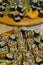 Nicely presented variety of homemade typical Japanese Maki Sushi rolls on a wooden board
