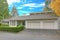 Nicely remodeled home exterior with boxwood hedge