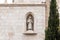 A niche with a sculpture of a Franciscan monk reading a sacred book, in the wall of a Franciscan monastery near Zion Gate of Jerus