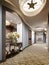 A niche in the wall of the hotel corridor with a mirror and a classic console with flowers and lighting