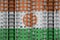 Niger flag depicted in paint colors on multi-storey residental building under construction. Textured banner on brick wall