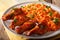 Nigerian food party: Jollof rice with fried chicken wings close-up. horizontal