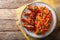 Nigerian food party: Jollof rice with fried chicken wings close-up. Horizontal top view