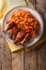 Nigerian food party: Jollof rice with fried chicken wings close-up. Vertical top view