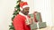 Nigerian men wearing red Santa holding many gift boxes with Christmas trees