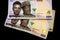 Nigerian money, one thousand Nigerian Naira bank notes, isolated on a plain black background.