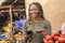 nigerian woman selling in a local nigerian market using her mobile phone and credit card to do a transaction online smiling