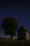 Night abandoned chapel under the stars in the night sky