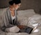 Night, bedroom and woman with smile for laptop on social media, chatting and texting on site of app. Bed, female person