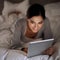 Night, bedroom and woman with smile for tablet on social media, chatting and texting on site of app. Bed, female person