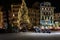 Night central street with Christmas tree and parked motorbikes under it.