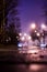 Night city alley with lanterns in the fog after rain.