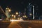 Night city Dubai with glowing light from the road and buildings near the metro station line