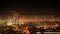 Night city industrial zone timelapse 4k. Smoke from the pipes of manufacturing. Residental aeria houses and car traffic