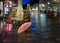 Night city light  pink umbrella  rainy season street    old town of tallinn panorama blurring bokeh city  people walking