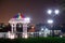 Night city. The light trails on the street. Slow shutter speed photo. The observation deck is illuminated by night-time