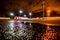 Night city after rain, lights illuminating the parking lot near the shopping mall.