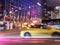 Night city street blurred light colorful neon cars and bus people walking modern building windows reflection urban life Tall