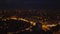 Night cityscape. Aerial descending footage of large city, illuminated streets and buildings in urban boroughs. Antalya