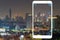 Night cityscape picture with a white mobile frame with virus icon notification point