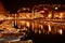 Night Cityscape river channel with moored barges. Rijeka city night lights in Croatia