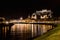 Night Cityscape Salzburg. View from the Salzach with Hohensalzburg Fortress and Cathedral, Salzburg, Austria