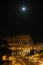 Night Colosseum with illumination. The moon in the sky