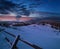 Night countryside hills, groves and farmlands in winter remote alpine mountain village. Ukraine, Voronenko