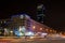 Night crossroad with traffic and skyscraper in the background