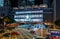 Night exterior view of Apple IFC Mall in Hong Kong. Lung Wo Rd and Man Yiu St crossing