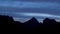 The night falls in a mountain valley. The clouds change color from multicolored to dark. TimeLapse