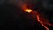 Night footage of flowing molten lava stream down on slope. Boiling magmatic material in volcano crater. Power of nature