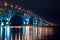 Night graceful bridge with arches and blue illumination