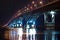 Night graceful bridge with arches and blue illumination