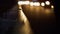 Night highway guardrail reflecting car beams closeup. Evening traffic lights